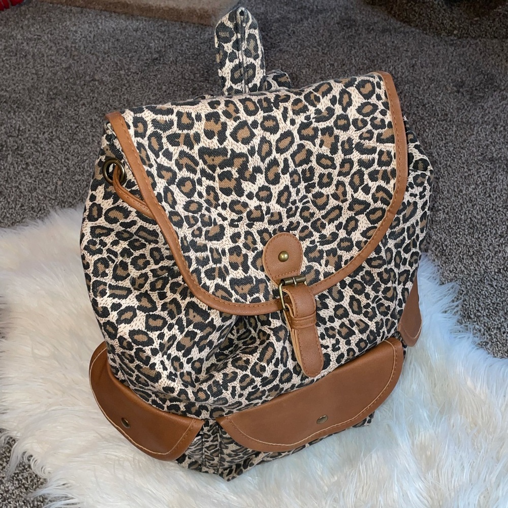 NWOT leopard magnetic close snap backpack with 3 outside pockets.